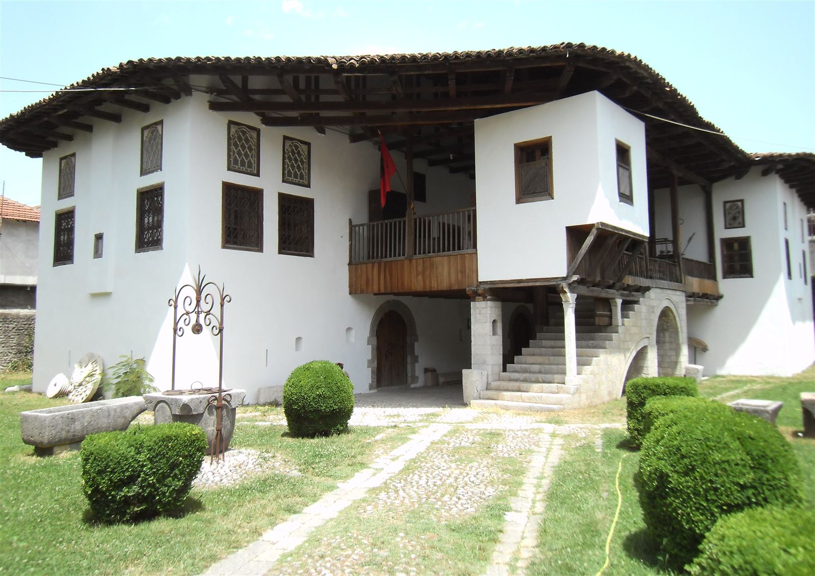 Traditional white stone Historical Museum building in Shkodra with a wooden balcony