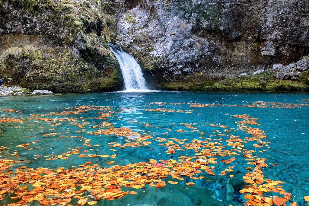 The Blue Eye of Theth, a turquoise spring pool below a small waterfall in Theth National Park