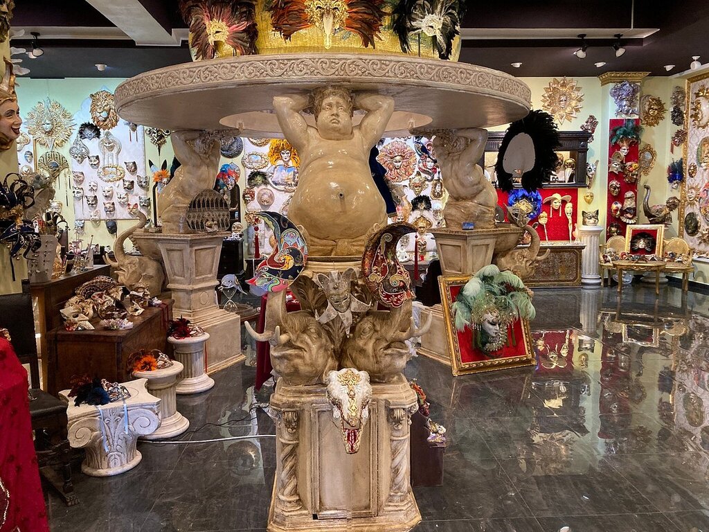 Ornate Venetian-style masks filling the Venice Art Mask Factory showroom in Shkodra